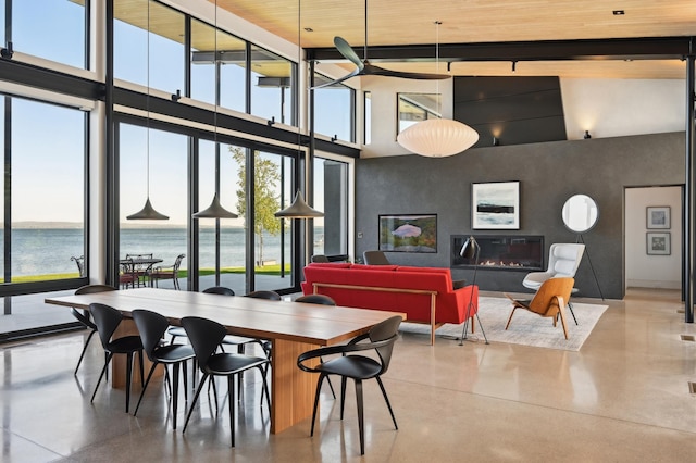 dining room with a water view, high vaulted ceiling, plenty of natural light, and wood ceiling