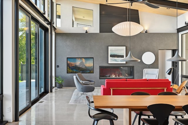 dining room with high vaulted ceiling and beam ceiling