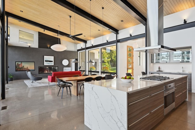 kitchen with stainless steel appliances, wood ceiling, a kitchen island, and beam ceiling