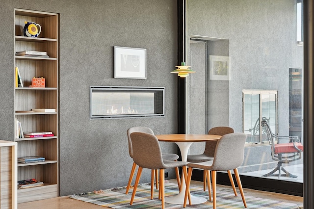 dining area with wood-type flooring and built in features