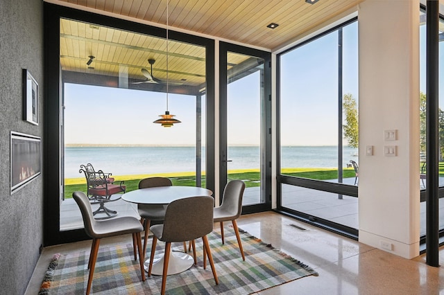 sunroom / solarium with a water view and wooden ceiling