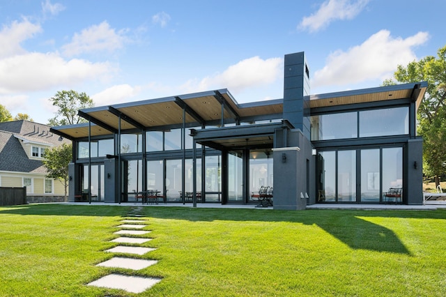 back of house featuring a lawn and a patio area