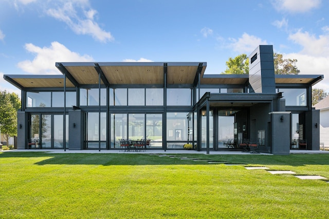 back of house featuring a yard and a patio area