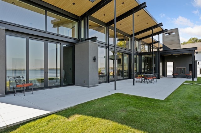 back of house with a yard and a patio area