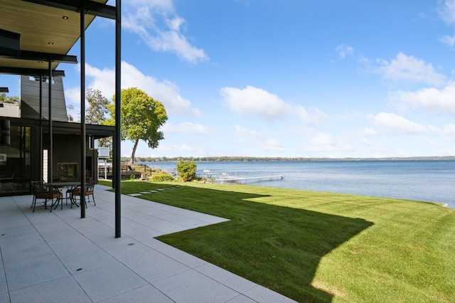 view of yard with a water view and a patio