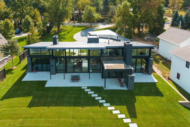 rear view of property featuring a gazebo, a patio, and a yard