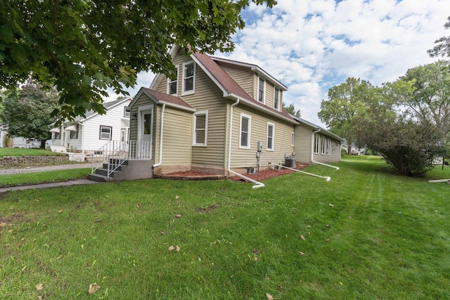 exterior space with central air condition unit, a patio, and a yard