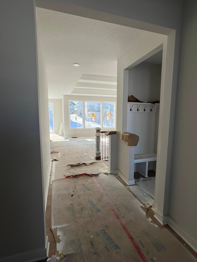 corridor featuring a textured ceiling