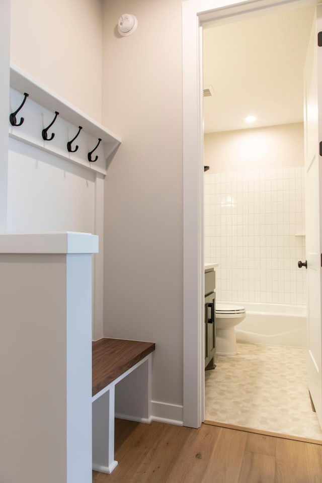 mudroom featuring wood finished floors and baseboards