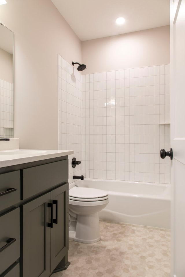 bathroom with vanity, toilet, and tub / shower combination