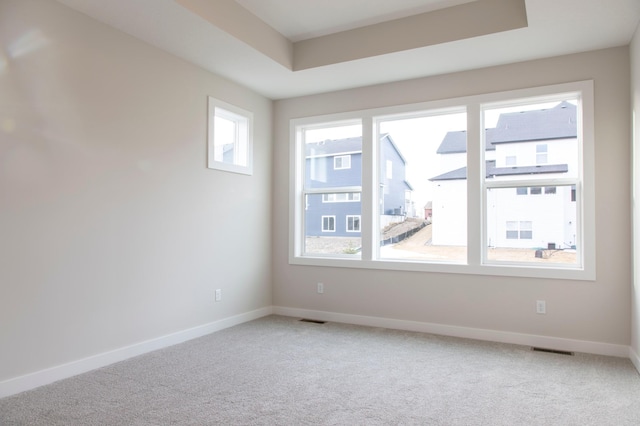 spare room with visible vents, baseboards, and carpet