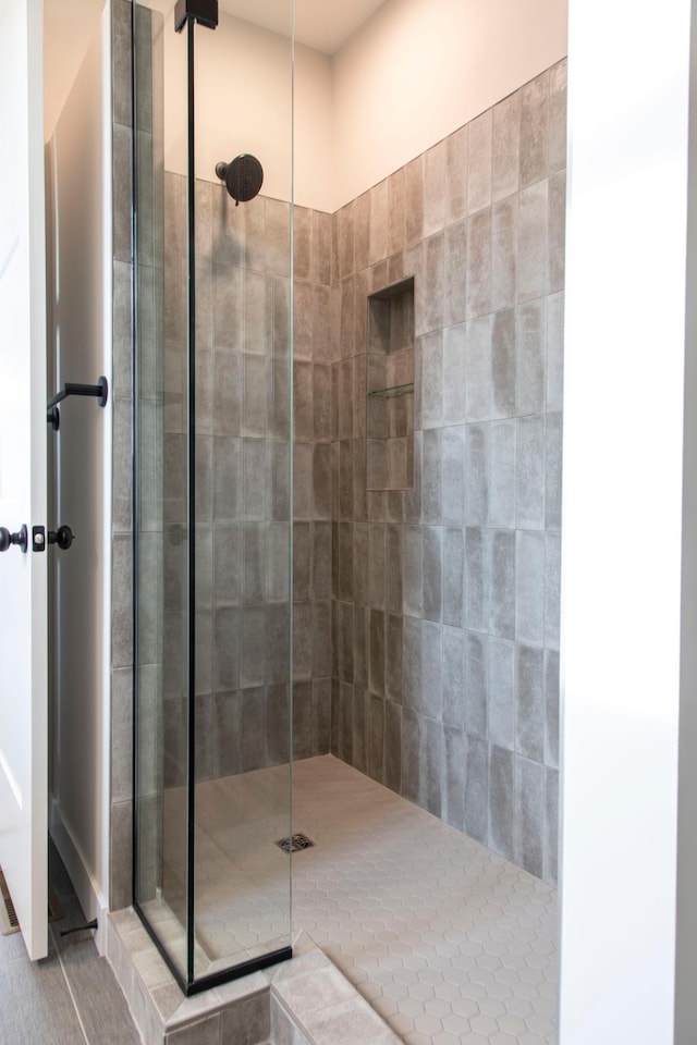 full bath featuring a tile shower