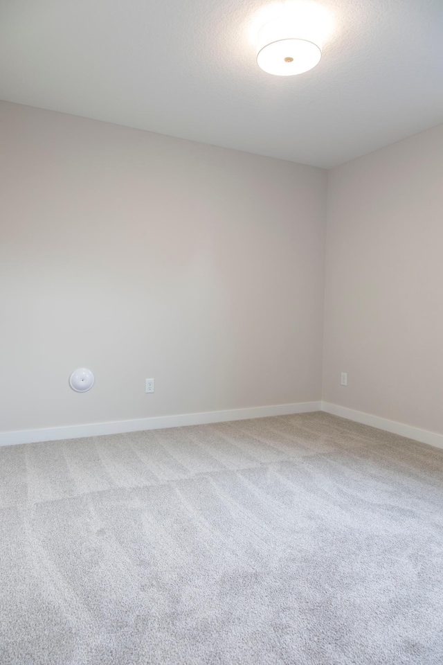 empty room with carpet flooring and baseboards