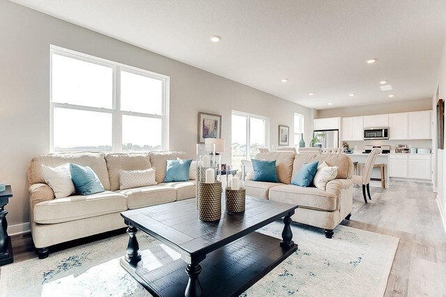 living room featuring light wood-style flooring and recessed lighting