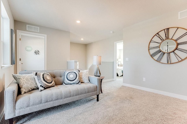 carpeted living room with recessed lighting, visible vents, and baseboards