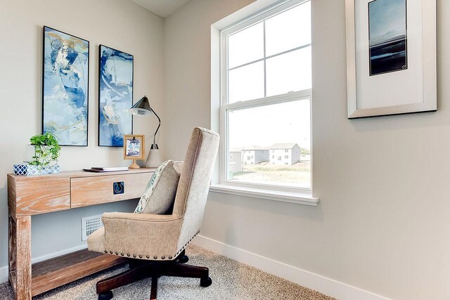 carpeted home office featuring baseboards