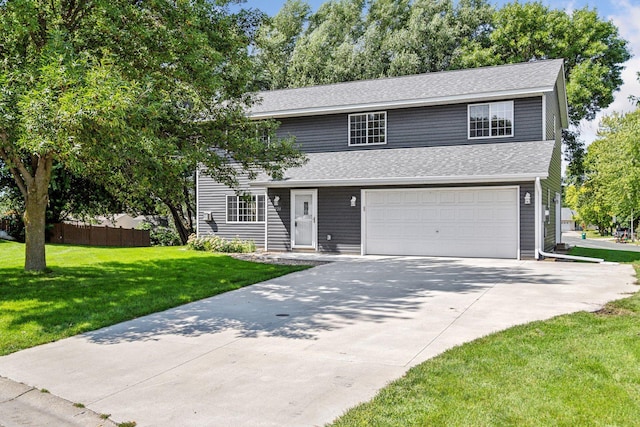 front of property with a garage and a front lawn