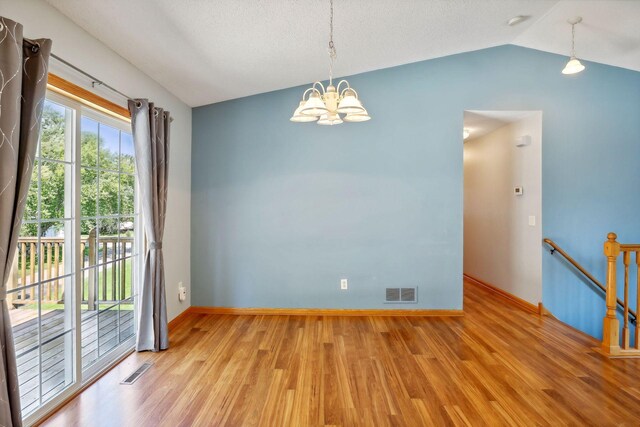 interior space featuring lofted ceiling, a notable chandelier, and light hardwood / wood-style floors