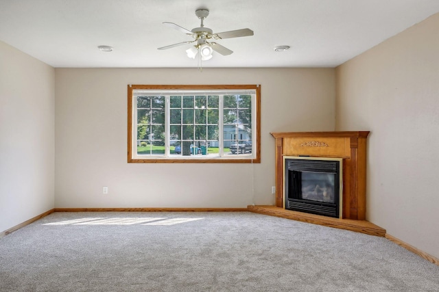 unfurnished living room featuring light carpet and ceiling fan