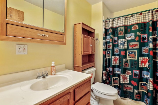 bathroom with vanity, toilet, and curtained shower