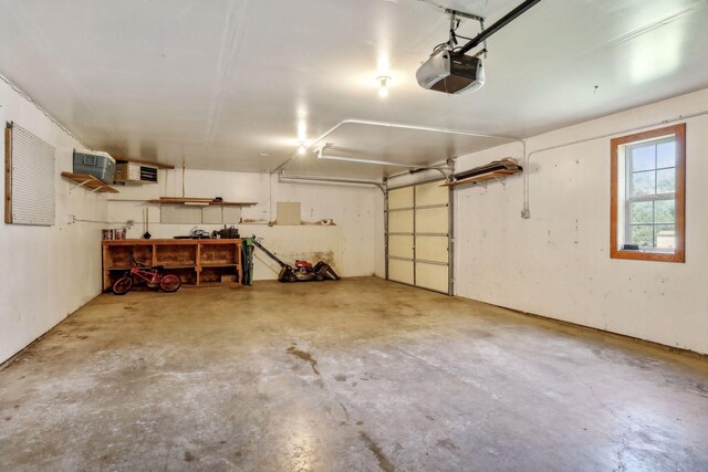 garage featuring a garage door opener and a workshop area