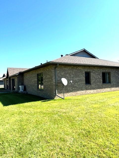 view of side of home featuring a yard