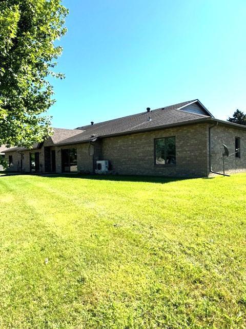 back of house with a lawn