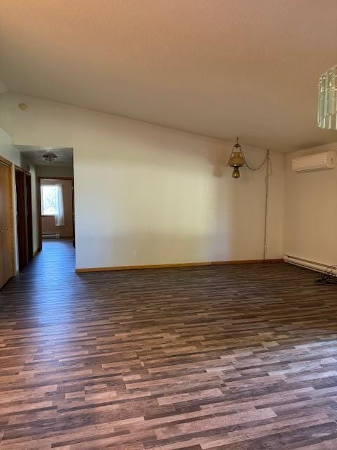 empty room featuring dark hardwood / wood-style flooring, vaulted ceiling, a wall unit AC, and a baseboard heating unit