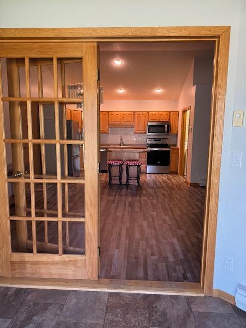 kitchen featuring lofted ceiling, sink, and stainless steel appliances