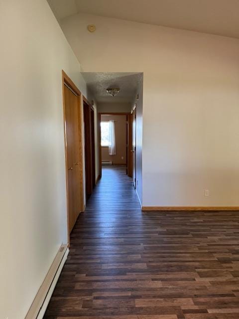 hall featuring vaulted ceiling, dark hardwood / wood-style floors, and a baseboard radiator