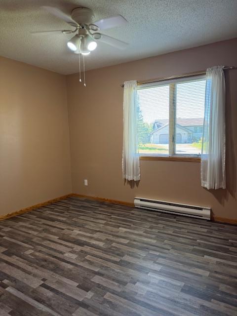 empty room featuring ceiling fan, a baseboard radiator, dark hardwood / wood-style flooring, and a textured ceiling