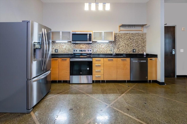 kitchen featuring backsplash, sink, and appliances with stainless steel finishes