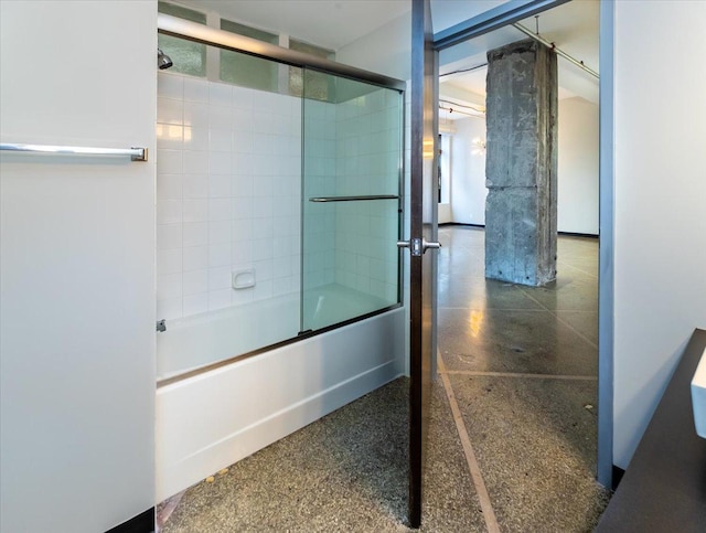 bathroom with shower / bath combination with glass door