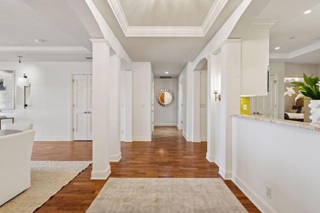 entrance foyer with crown molding, dark hardwood / wood-style flooring, and decorative columns