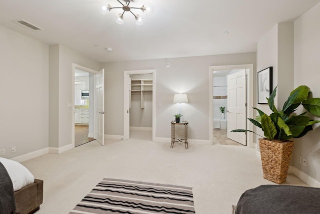 carpeted bedroom with a spacious closet and a closet