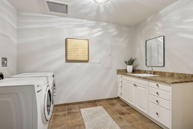 laundry area featuring cabinets, independent washer and dryer, and sink