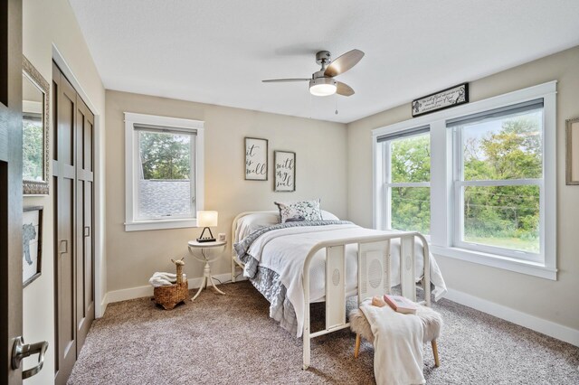 carpeted bedroom with ceiling fan