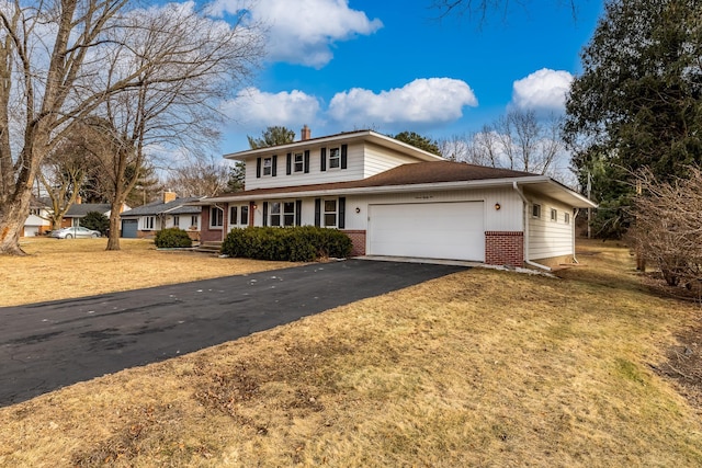 view of front of house featuring a front yard and a garage