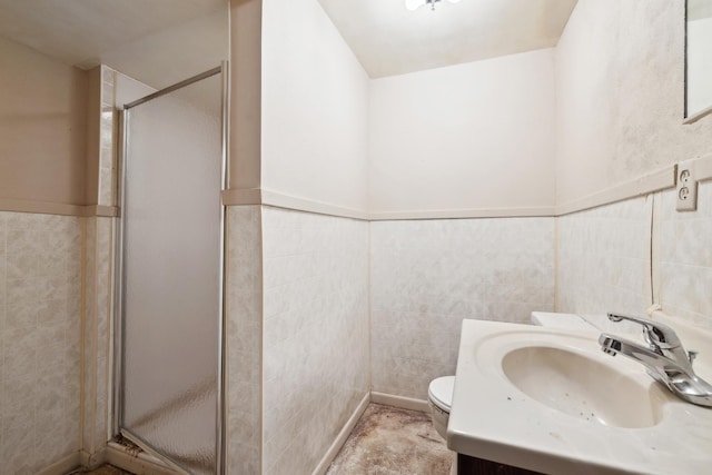 bathroom with vanity, tile walls, and walk in shower