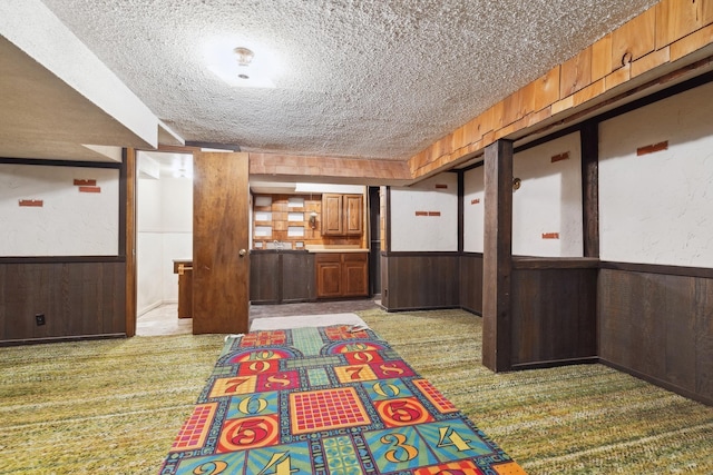 interior space featuring wood walls and a textured ceiling