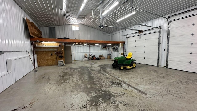 garage featuring metal wall and a garage door opener