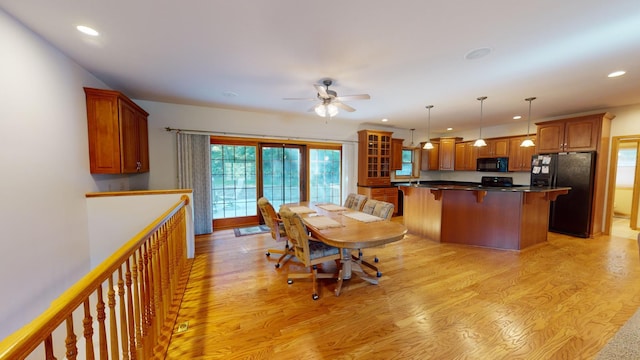 dining space with recessed lighting, a ceiling fan, and light wood-style floors