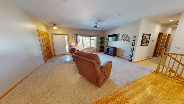 living room featuring light carpet, recessed lighting, visible vents, and baseboards