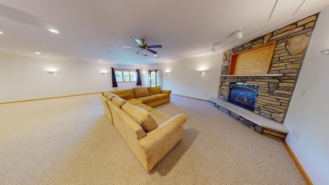 living area with a stone fireplace, light carpet, a ceiling fan, baseboards, and crown molding