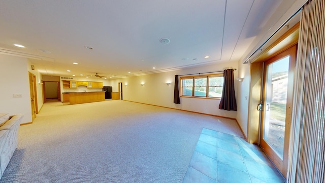 unfurnished living room with crown molding, recessed lighting, light colored carpet, and baseboards