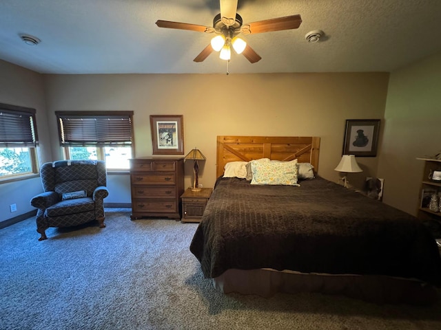 bedroom with baseboards, ceiling fan, a textured ceiling, and carpet