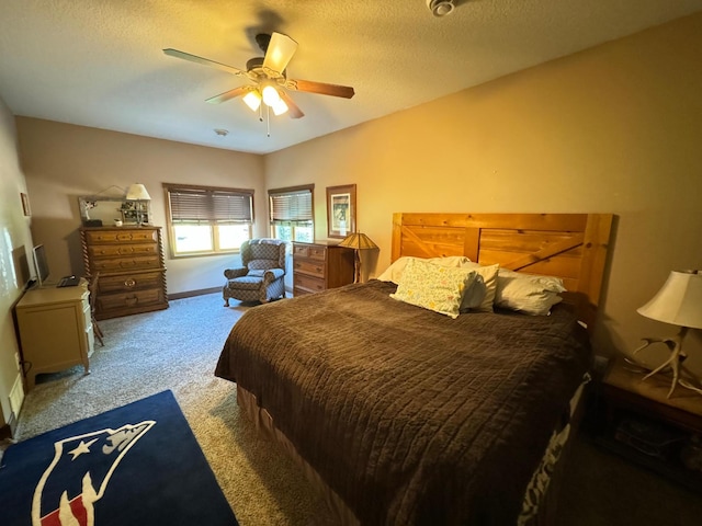 bedroom featuring baseboards, a textured ceiling, ceiling fan, and carpet flooring