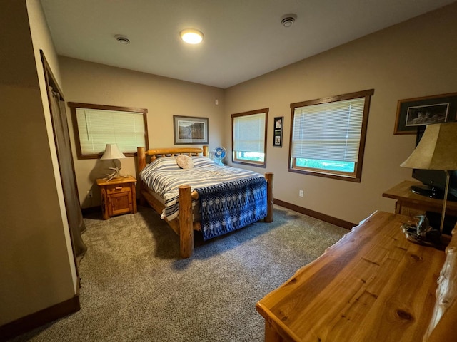 bedroom featuring visible vents, baseboards, and carpet