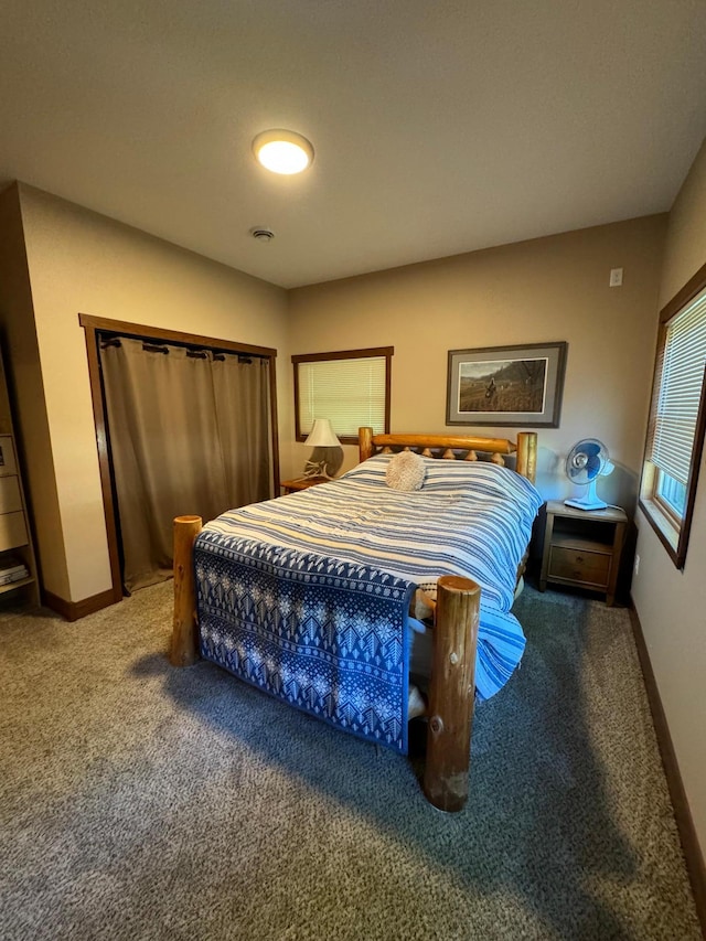 bedroom featuring baseboards and carpet