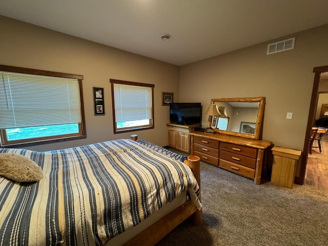 bedroom with visible vents and carpet flooring